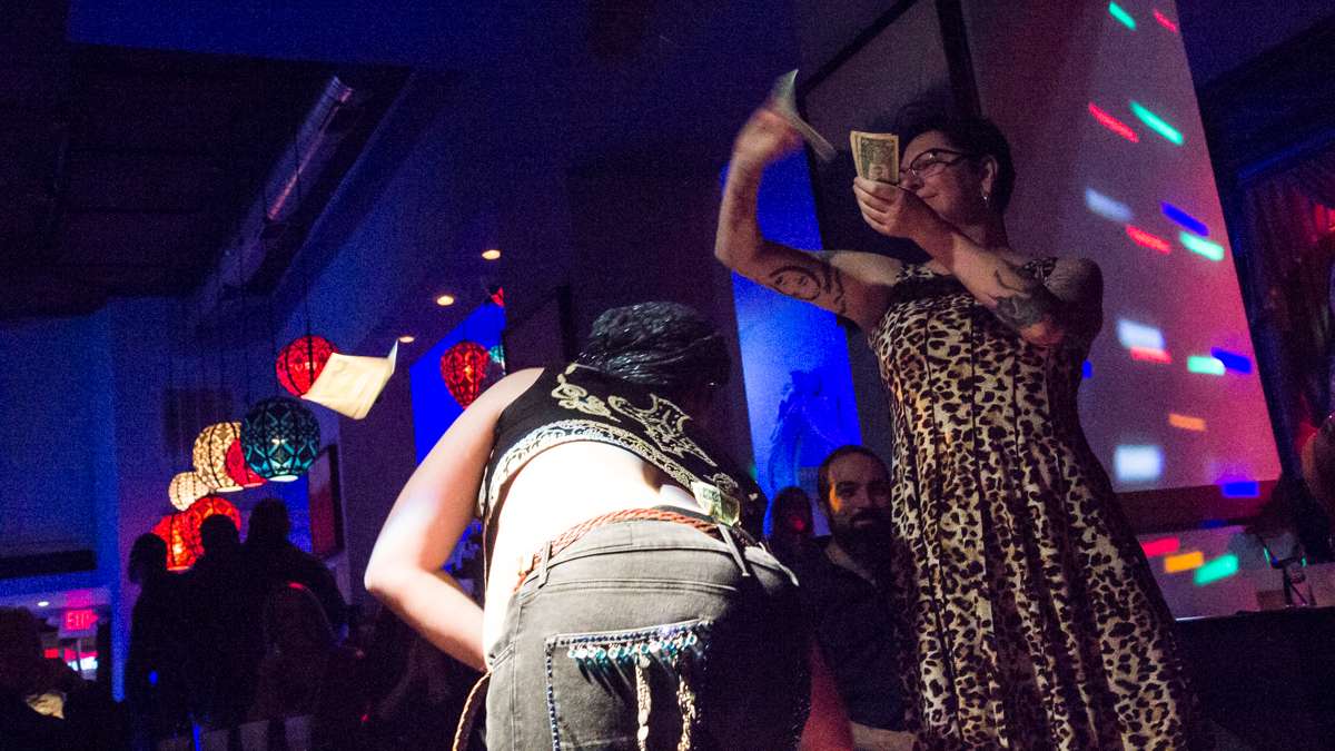 Dancer Roberto Mejía has money rained on him at the 5th annual Belly Dancers Fight for Air.