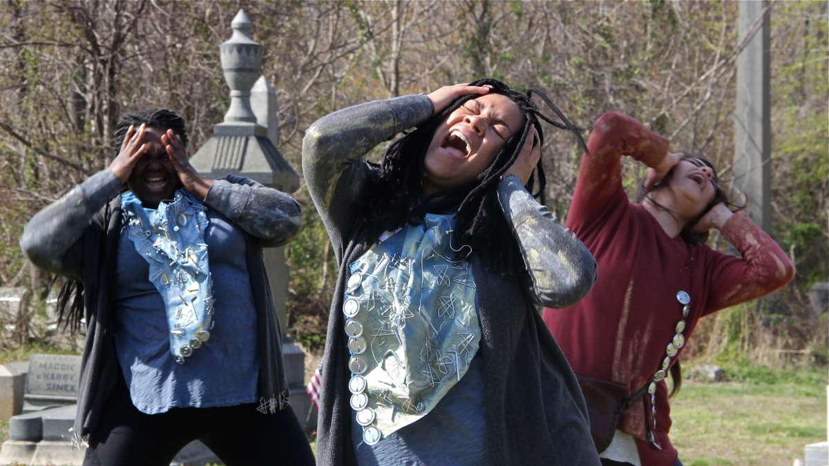 The cast of Beowulf/Grendel (from left) Ainye AnnaDora, Nia Benjamin, and Merri Roshoyan, rehearse in Mount Moriah Cemetery. (Emma Lee/WHYY)