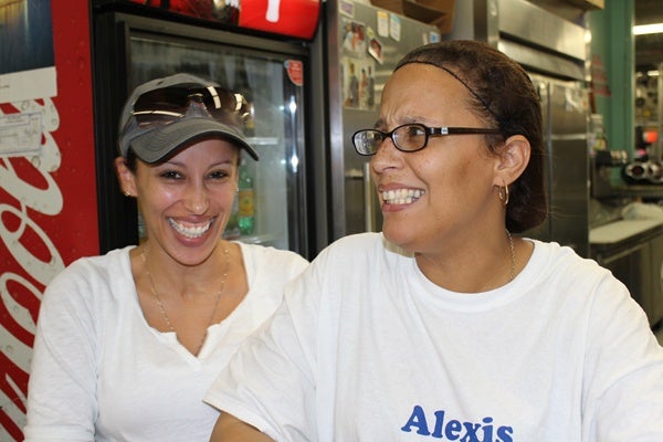 <p><p>Alexis Hernandez (right), owner of Alexis Caribbean Delight, started selling Puerto Rican fare from a food truck. Now she's settled at the Berlin Farmers Market. Her sister often stops by to eat — and to lend a hand. (Elisabeth Perez-Luna/WHYY)</p></p>
