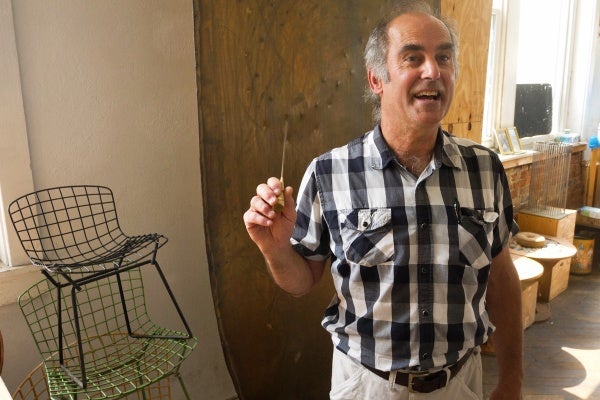Val Bertoia continues his father's tradition of crafting sound sculptures at the Bertoia Studio in Bally, Pa. (Charlie Kaier/WHYY)