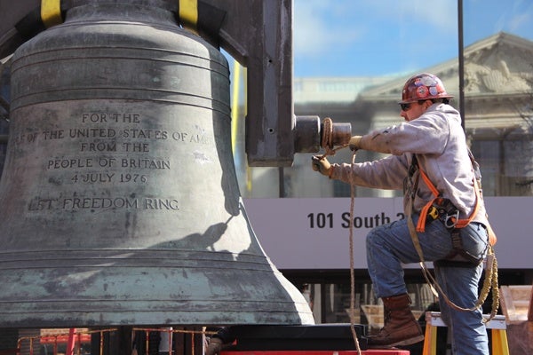 <p><p>Ironworker Michael Regan secures the Bicentennial Bell before it is lifted into a box. The bell will remain in the National Historical Park's museum storage until a new display is completed. (Emma Lee/for NewsWorks)</p></p>
