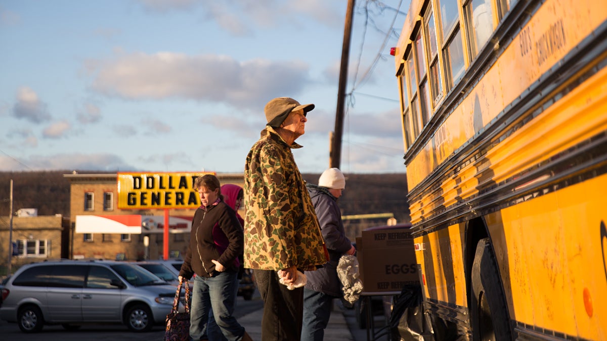 Bill Snyder waits for a hot meal from Jim Bowers’ mobile food pantry in the parking lot of the Dollar General in Mt. Carmel