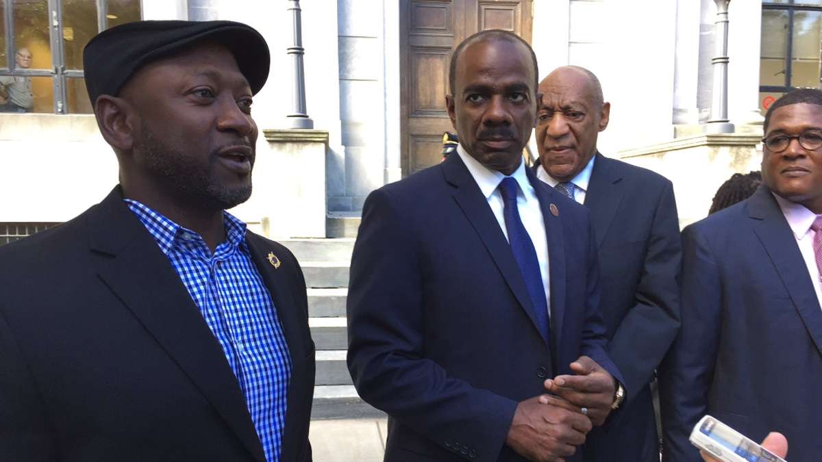 Artist bird Milliken says she was moved protest outside of the Montgomery County Courthouse after seeing the steady stream of celebrities — including comedians Joe Torry and Lewis Dix, shown here — who have escorted and supported Bill Cosby, who is standing trial for sexual assault.