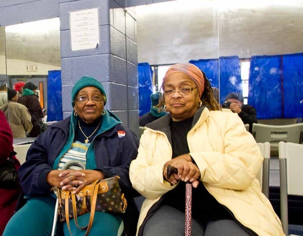 <p><p>Rochele Hilton (right) and Thelma Pienson (left) wait for a polling station to open at the Awbury Recreation Center in Germantown. Hilton, a lifelong Germantown resident, says she has missed only one election in 52 years of voting. (Brad Larrison/For NewsWorks)</p></p>
