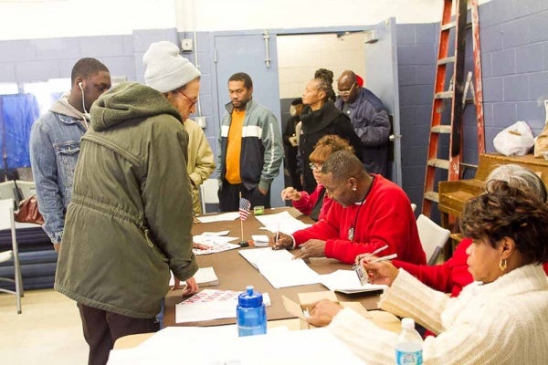 Voters line up to check in with poll workers at the Awbury Recreation Center in the Germantown neighborhood of Philadelphia. (Brad Larrison for WHYY)
