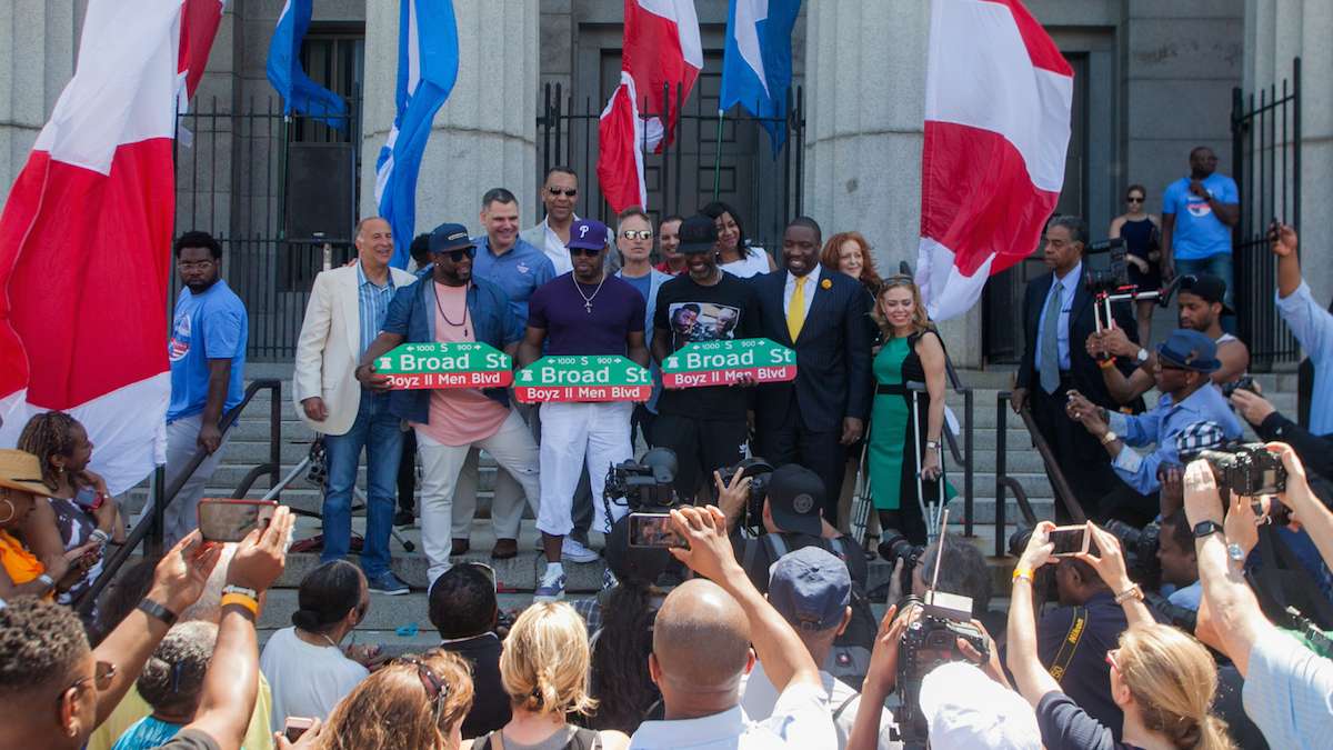 Boyz II Men pose with their newly unveiled Boyz II Men Boulevard signs in front of their alma mater the Philadelphia High School for Creative and Performing Arts.