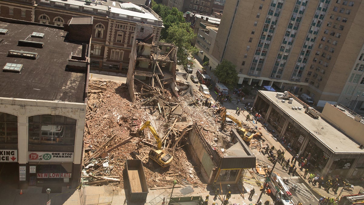  Rescue personnel search the rubble of a building that collapsed at the corner of Market and 22nd streets in Center City Philadelphia on June 5, 2013. Philadelphia District Attorney Seth Williams on Monday said that contractor Griffin T. Campbell has been charged with third-degree murder, as well as manslaughter, in connection with the collapse. (Lindsay Lazarski/WHYY)   