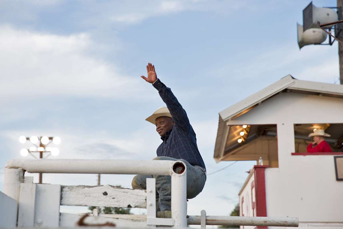 Troy Alexander waves to a fan before the start of the Cowtown Rodeo on a Saturday night in Pilesgrove, New Jersey. (Lindsay Lazarski/WHYY)