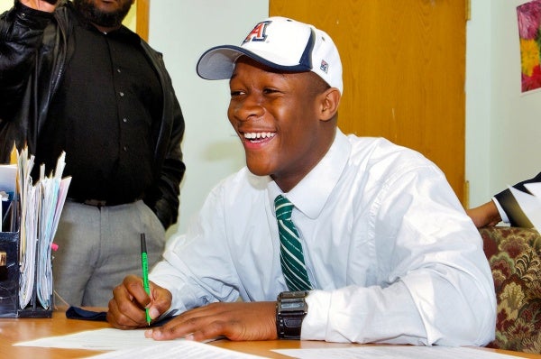 Standout cornerback Will Parks signs his letter of intent to attend the University of Arizona and play football for the Wildcats. (Bas Slabbers/for NewsWorks)