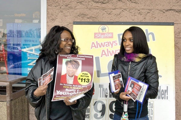 Youngblood's campaign manager Thera Martin Milling and a campaign volunteer stand outside of ShopRite at Olney One Shopping Center. (Bas Slabbers/for NewsWorks)