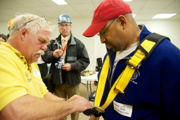 <p><p>Mayor Michael Nutter gets his harness fitted before heading to the roof. (Bas Slabbers/for NewsWorks)</p></p>
