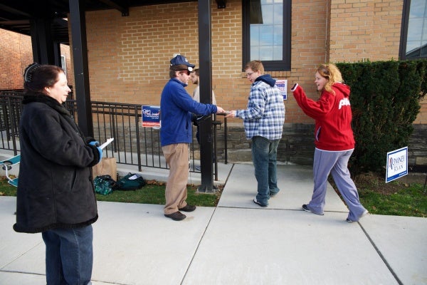 <p><p>Voters are given sample ballots as they enter the polling station. (Bas Slabbers/for NewsWorks)</p></p>
