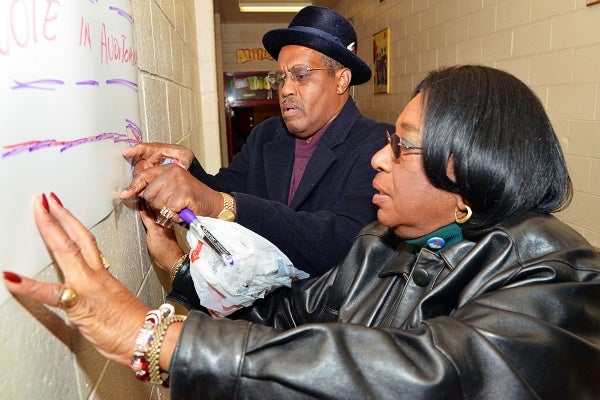 <p><p>Ninth District Councilwoman Marian B. Tasco adjusts signs at the Finley Recreation Center. (Bas Slabbers/for NewsWorks)</p></p>
