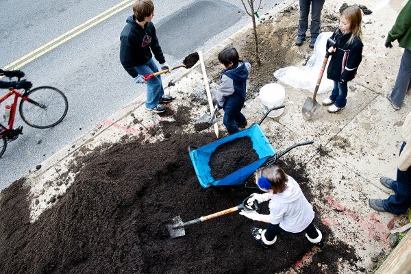 <p><p>Students spread mulch out at the tree planting site outside of James Dobson Elementary. (Bas Slabbers/for NewsWorks)</p></p>
