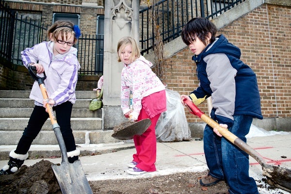 <p><p>Dobson Elementary students Jade, 7, Hope, 5, and Jaden, 7, excavate a hole for one of the five trees. (Bas Slabbers/for NewsWorks)</p></p>
