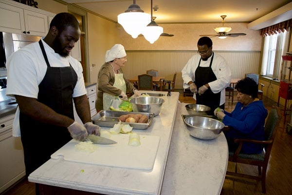 <p><p>Wesley Enhanced Living at Stapeley residents Angela DeBose and Estelle Kameika help Chef Greg Brown and cook Norman Nelson prepare 400 "Turkeys from Heaven" meals. (Bas Slabbers/for NewsWorks)</p></p>
