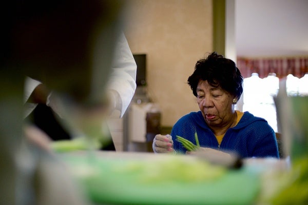 <p><p>Resident Angela DeBose cleans the peas. (Bas Slabbers/for NewsWorks)</p></p>
