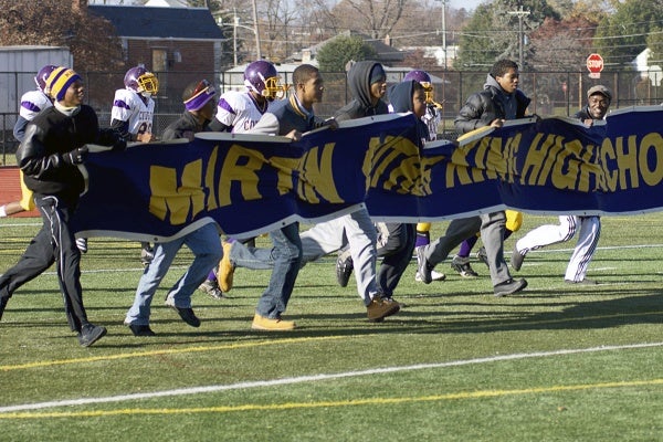 <p><p>Fans of the MLK High Cougars proudly display the school's banner during pregame warmups at Benjamin L. Johnson Memorial Stadium. (Bas Slabbers/for NewsWorks)</p></p>
