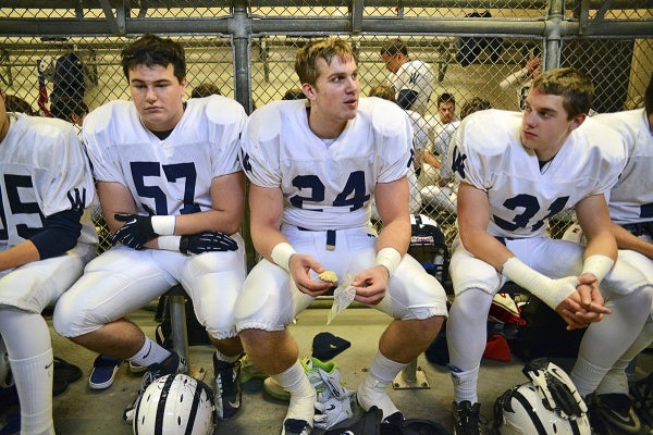 <p><p>In the Wyomissing locker room before the game, Connor Reedy, team captain and Notre Dame recruit Alex Anzalone and Scott McAvoy sit quietly as noise from a raucous Imhotep room fills the air. (Bas Slabbers/for NewsWorks)</p></p>
