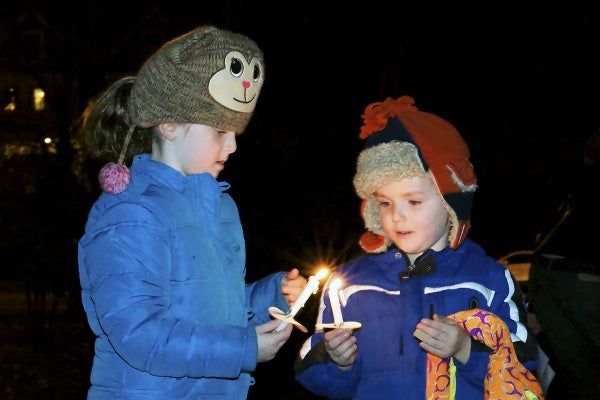 <p><p>Kids share a flame to light the next candle. (Bas Slabbers/for NewsWorks)</p></p>
