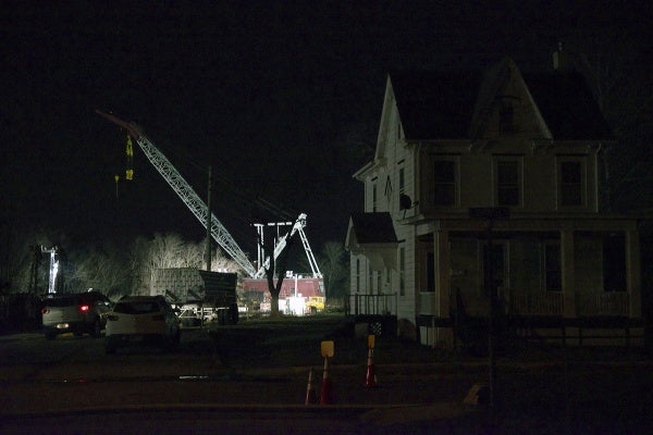 <p><p>The crane is seen at work behind an evacuated house alongside the track on Tuesday night. (Bas Slabbers/for NewsWorks)</p></p>
