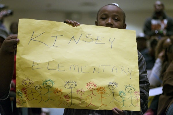 <p>A Kinsey Elementary student holds up a sign. (Bas Slabbers/for NewsWorks)</p>
