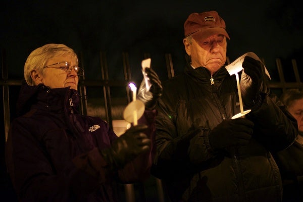 <p>Names of victims of the Sandy Hook shooting are read by people attending the vigil. (Bas Slabbers/for NewsWorks)</p>
