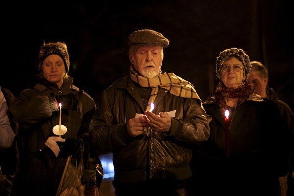 <p>Bruce McNeel reads one of the names. (Bas Slabbers/for NewsWorks)</p>
