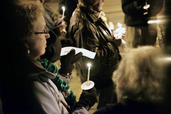 <p>Names of victims of the Sandy Hook shooting are read by people attending the vigil. (Bas Slabbers/for NewsWorks)</p>
