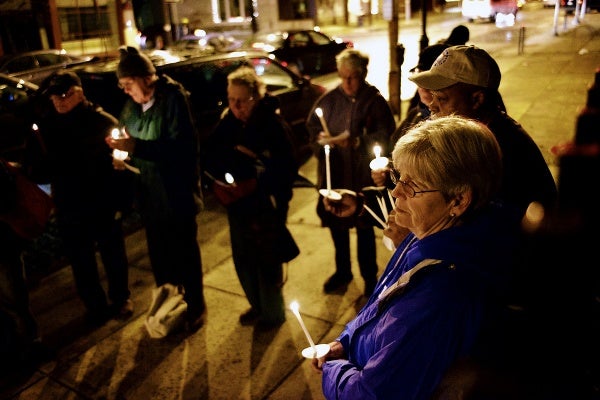 <p>Names of victims of the Sandy Hook shooting are read by people attending the vigil. (Bas Slabbers/for NewsWorks)</p>
