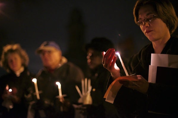 <p><p>Rev. Lorelei Toombs of First United Methodist Church of Germantown protects her candle from the wind. (Bas Slabbers/for NewsWorks)</p></p>
