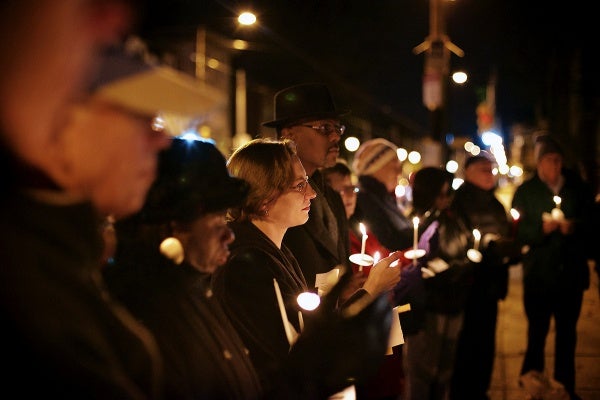 <p>Names of victims of the Sandy Hook shooting are read by people attending the vigil. (Bas Slabbers/for NewsWorks)</p>
