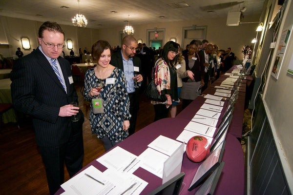 <p><p>Guests browse items offered at the silent auction. (Bas Slabbers/for NewsWorks)</p></p>
