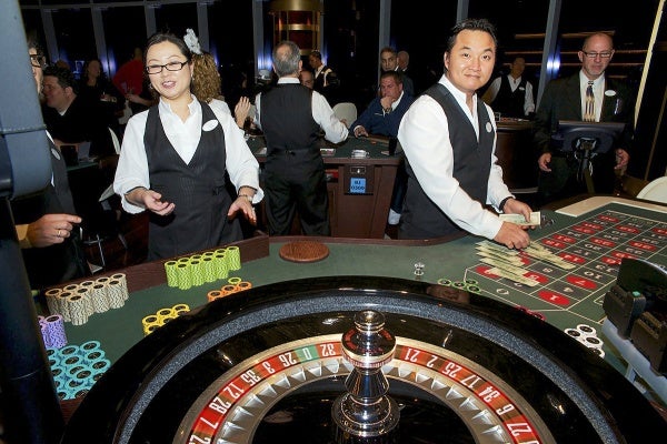 <p><p>Dealers at work at one of the tables of the Revel Casino. (Bas Slabbers/for NewsWorks)</p></p>
