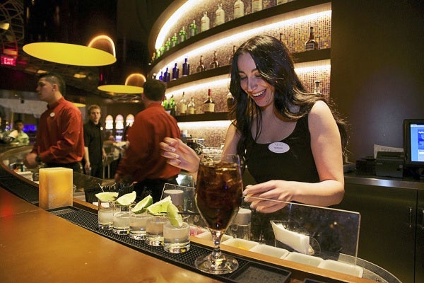 <p><p>Morgan works at the bar in one of the lounge areas. (Bas Slabbers/for NewsWorks)</p></p>
