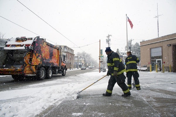 <p>It took the firemen no time to clear the area in front of the fire house. (Bas Slabbers/for NewsWorks)</p>

