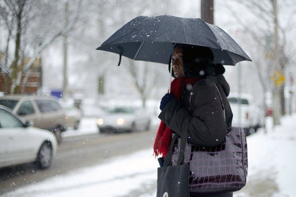 <p><p>A woman with an umbrella is seen waiting for the bus on the corner of Germantown and Mt. Pleasant avenues. (Bas Slabbers/for NewsWorks)</p></p>
