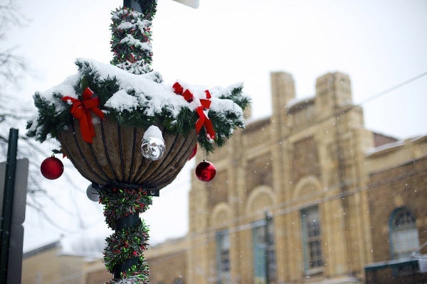 <p>Holiday decorations on the street posts catch some of the snow. (Bas Slabbers/for NewsWorks)</p>
