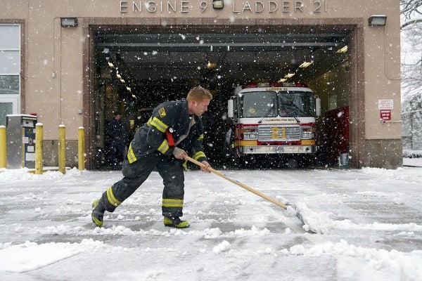 <p><p>At the Carpenter Lane fire station, a firefighter is seen shoveling snow to clear a path for the fire trucks. (Bas Slabbers/for NewsWorks)</p></p>
