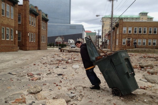 <p>In the hope to earn a buck, a man collects metal from the site of the demolished AC boardwalk. 

 (Jana Shea/for NewsWorks)</p>
