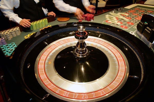 <p>Dealers at work at one of the tables of the Revel Casino. (Bas Slabbers/for NewsWorks, file)</p>
