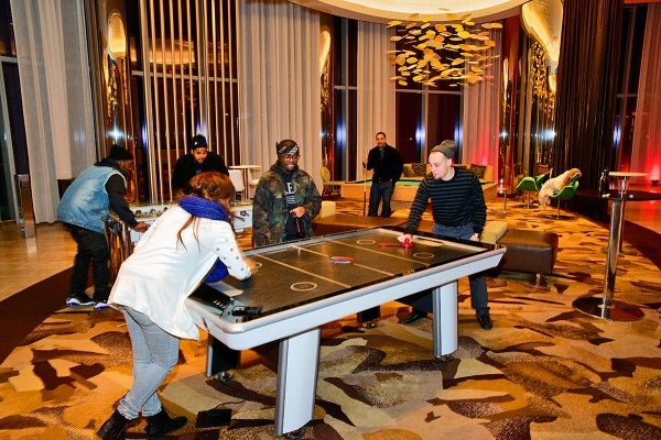 <p>This group of friends found games to enjoy themselves at the O2 lounge area at the Revel Resorts complex. (Bas Slabbers/for NewsWorks, file)</p>

