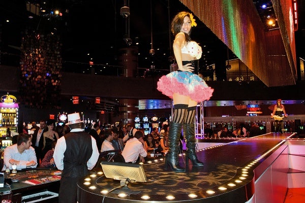<p>Gamblers and burlesque dancers are seen at the gaming floor of the Revel casino. (Bas Slabbers/for NewsWorks, file)</p>
