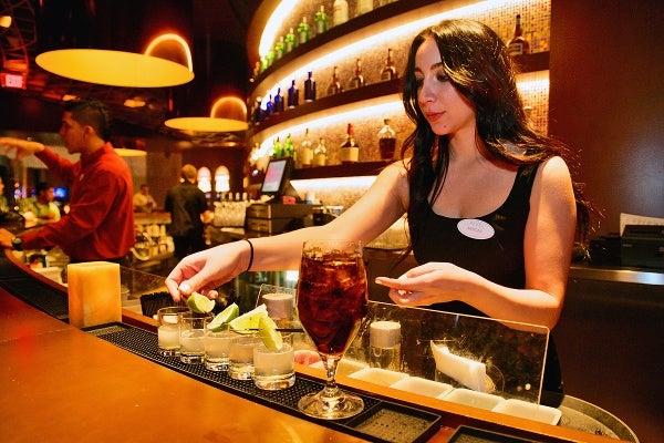 <p>Morgan, a Revel Ultra Lounge bar tender prepares drinks. (Bas Slabbers/for NewsWorks, file)</p>
