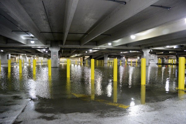 <p>4:30pm - Water stands in a parking garage under one of the casinos in AC. Pumps are deployed to get the water out.  (Bas Slabbers/for NewsWorks)</p>

