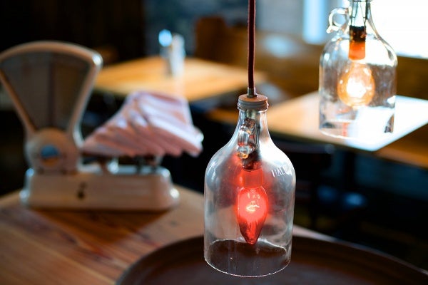 <p><p>Detail of the recycled cider jug lighting on the second floor. (Bas Slabbers/for NewsWorks)</p></p>
