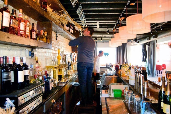 <p><p>The bar and rustic shelving are among the many reclaimed wood projects throughout the restaurant. (Bas Slabbers/for NewsWorks)</p></p>

