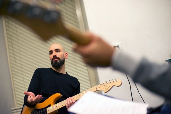 <p>Jeff Chivitte pitches the surf song Pipeline to the group. (Bas Slabbers/for NewsWorks)</p>
