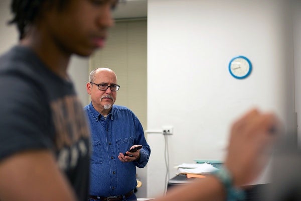 <p>Ed Wise looks at notes in the song roadmap that Darren Davis makes on the whiteboard. (Bas Slabbers/for NewsWorks)</p>
