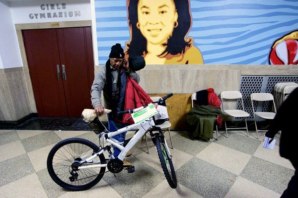 <p><p>A local resident holds the bicycle he won in Thursday night's raffle. (Bas Slabbers/for NewsWorks)</p></p>
